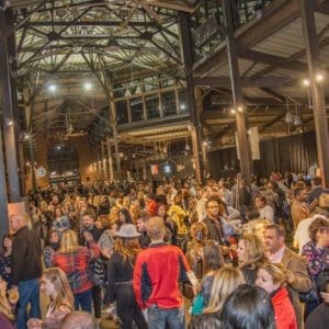 An image showing people packed in side one of Eastern Market's sheds.