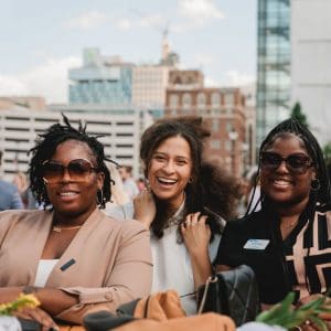 Event attendees participating in a safe and inclusive conference 3 women attending business event