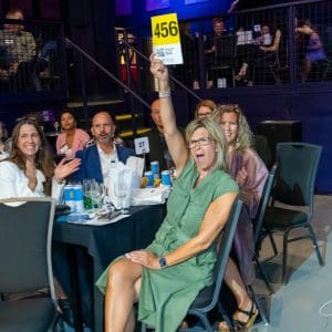 Woman bidding at silent auction