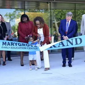 Group of people cutting a ribbon at a grand opening