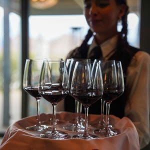 Server at corporate incentive event passing glasses of wine Server holding glasses of wine